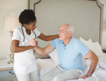 Caregiver assisting an old man