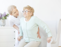 Caregiver assisting an old woman